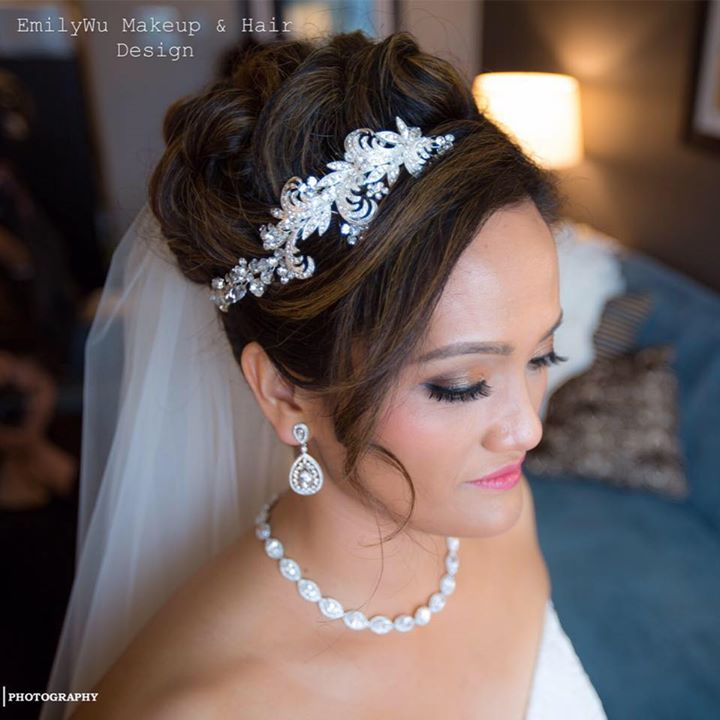 Bridal updo with a jeweled hairpiece and veil.